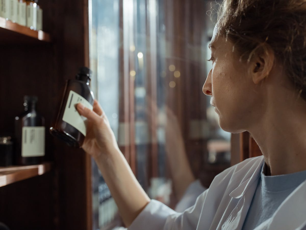 Pharmacist organising medication shelves