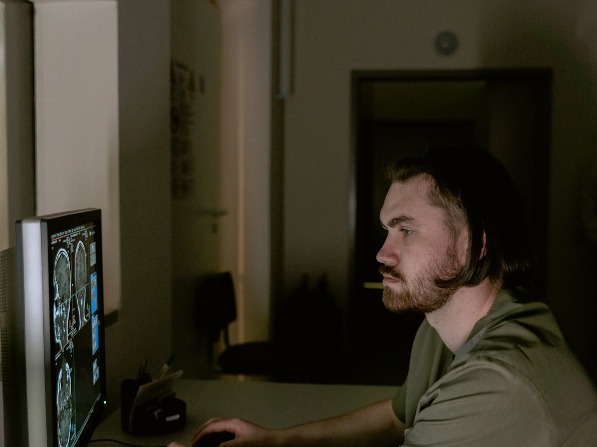 Radiologist reviewing scan images on a workstation
