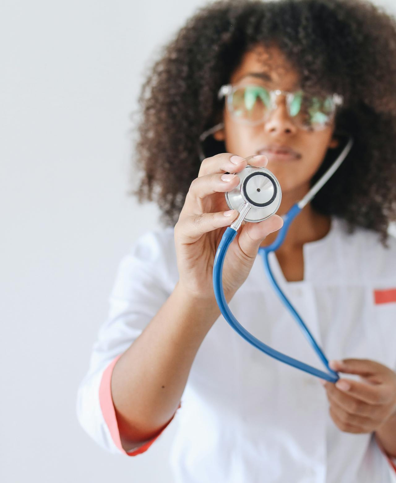 Black female doctor in a modern clinic reviewing a patient chart